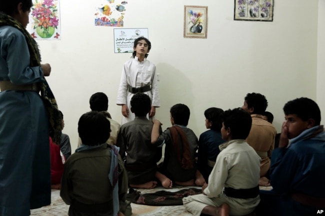 Boys recite poems during a session at a rehabilitation center for former child soldiers in Marib, Yemen, in this July 25, 2018 photo.