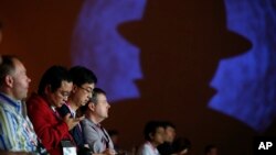 FILE - People attend a presentation on hacking a city during the Black Hat conference, Aug. 6, 2015, in Las Vegas. The annual computer security conference draws thousands of hackers and security professionals to Las Vegas.