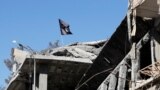FILE - A flag of Islamic State militants is pictured above a destroyed house in Raqqa, Syria, Oct. 18, 2017. The group's leader, Abu al-Hassan al-Hashimi al-Qurayshi, was killed recently in battle, the IS spokesman said in audio released Nov. 30, 2022.