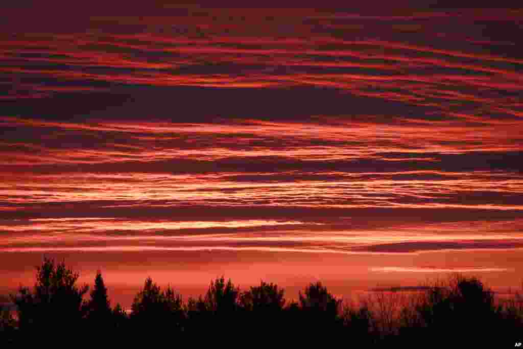 The sunrise colors the sky above Calais, Vermont, USA.