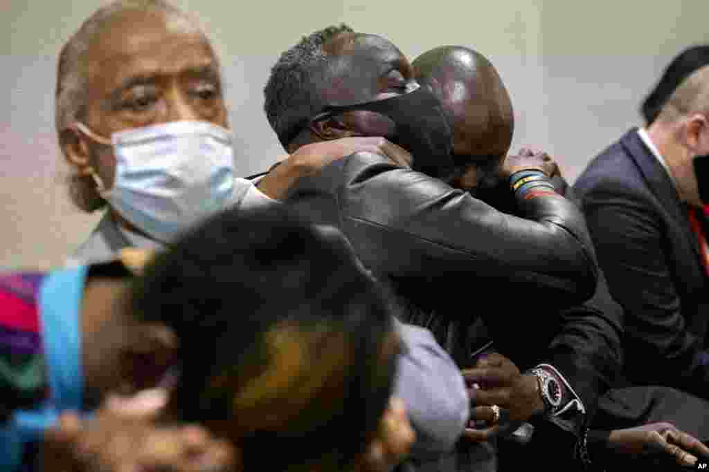 Ahmaud Arbery&#39;s father Marcus Arbery, center, his hugged by his attorney Benjamin Crump after the jury convicted Travis McMichael in the Glynn County Courthouse in Brunswick, Ga.&nbsp;Greg McMichael and his son, Travis McMichael, and a neighbor, William &quot;Roddie&quot; Bryan, charged in the death of Ahmaud Arbery were convicted of murder in the fatal shooting.