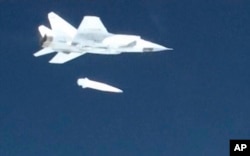 In this video grab provided by RU-RTR Russian television via AP television, March 1, 2018, a Russian MiG-31 fighter jet releases the new Kinzhal hypersonic missile during a test at an undisclosed location in Russia.