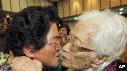 South Korean mother Kim Rye-jung, 96, right, kisses her North Korean daughter Woo Jung Hye during the Separated Family Reunion Meeting at Diamond Mountain in North Korea, 30 Oct 2010.