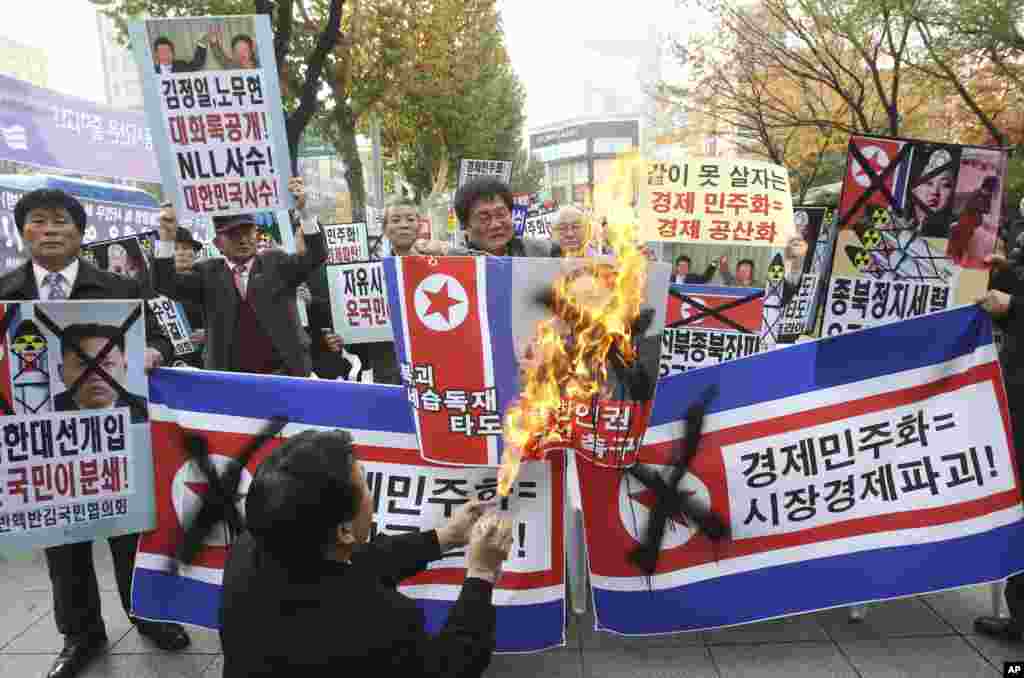 South Korean protesters burn a portrait of North Korean leader Kim Jong Un during a rally to mark the second anniversary of North Korea’s artillery attack on the Yeonpyeong island, Seoul, South Korea, November 23, 2012. 