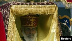 FILE—An Ethiopian orthodox priest carries the so-called "tabot" on his head, an engraved wooden or stone slab containing the Ten Commandments under layers of rich cloth during annual Epiphany celebrations of the Ethiopian Orthodox Church in Addis Ababa, January 20, 2004.