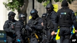 Near the start of a training exercise for London's emergency services, armed police officers stand near the disused Aldwych underground train station in London, June 30, 2015.