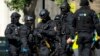 Near the start of a training exercise for London's emergency services, armed police officers stand near the disused Aldwych underground train station in London, June 30, 2015.