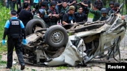 Military personnel inspect the site of a bomb attack at Krong Pinang District district in the troubled southern province of Yala, Thailand, Sept. 23, 2016.