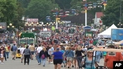 A crowd walks along part of the fair grounds at the Iowa State Fair, in the state capital Des Moines, August 12, 2011