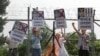 Members of South Korean conservative group shout slogans after burning an effigy of North Korean leader Kim Jong Un and North Korea's flag during a rally denouncing the North Korea at the Imjingak Pavilion near the border village of Panmunjom, which has s