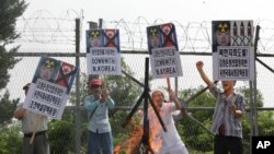 Members of South Korean conservative group shout slogans after burning an effigy of North Korean leader Kim Jong Un and North Korea's flag during a rally denouncing the North Korea at the Imjingak Pavilion near the border village of Panmunjom, which has s