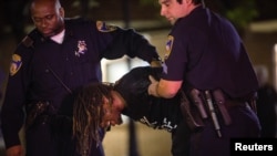 A demonstrator is taken into custody after defying a citywide curfew in Baltimore, Maryland, May 2, 2015. Thousands of people took to the streets of Baltimore as anger over the death of young black man Freddie Gray turned to hopes for change following swift criminal charges against six police officers. 