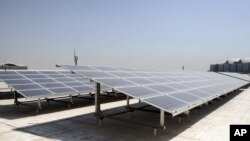 Solar panels are seen on the roof of the Qatar National Convention Center (QNCC) in Doha, Qatar. 