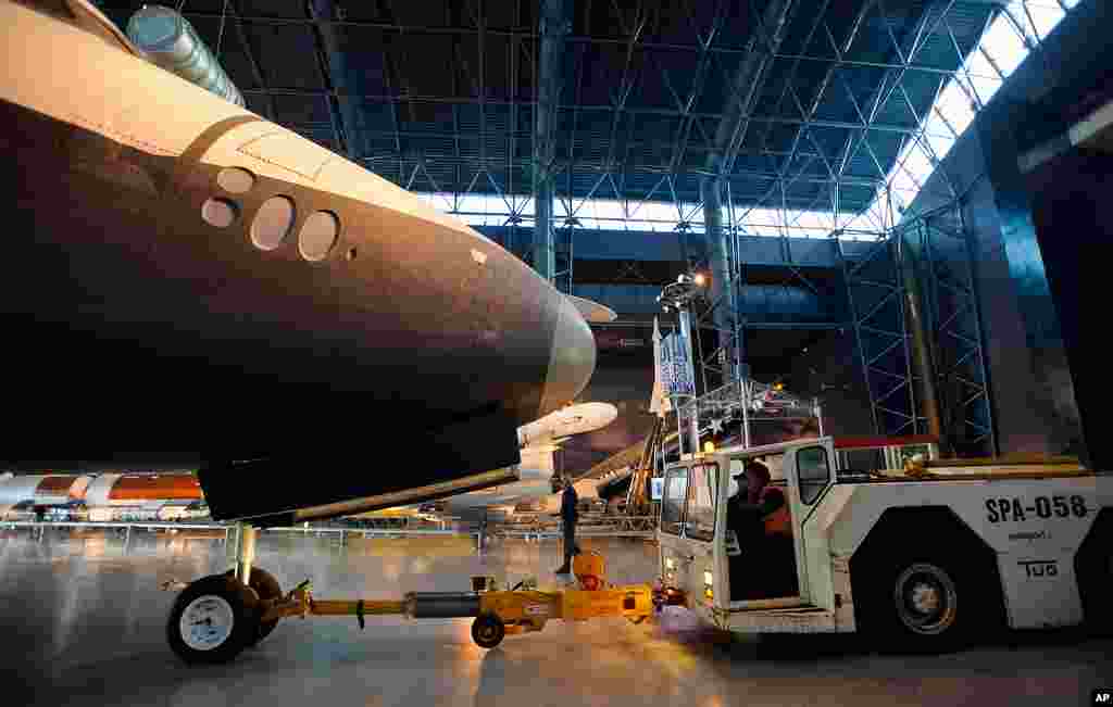 Space Shuttle Enterprise is prepared to be rolled from the Space Hangar at the Steven F. Udvar-Hazy Center prior to a transfer ceremony, in Chantilly, Virginia. (NASA/Paul E. Alers)
