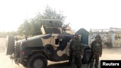 Afghan soldiers stand guard near the site of a blast in Kabul, Afghanistan, July 15, 2018. 