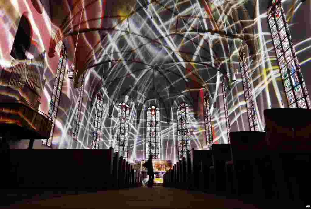 The inside of the Katharinen church is illuminated during a rehearsal for the "Luminale" light festival in Frankfurt, Germany.