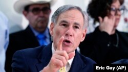 FILE - In this March 16, 2020 file photo, Texas Gov. Greg Abbott speaks during a news conference in San Antonio. 