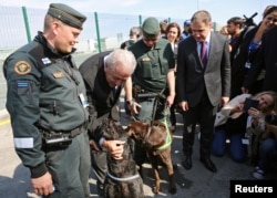 EU Commissioner of Migration Dimitris Avramopoulos poses for a picture with border police from Finland during the official launch of the European Union's Border and Coast Guard Agency at a border crossing on the Bulgarian-Turkish border in Kapitan Andreevo, Bulgaria, October 6, 2016.