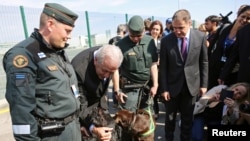 EU Commissioner of Migration Dimitris Avramopoulos poses for a picture with border police from Finland during the official launch of the European Union's Border and Coast Guard Agency at a border crossing on the Bulgarian-Turkish border in Kapitan Andreev