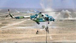 FILE - In this photo from the Russian Defense Ministry Press Service, troops disembark from a Chinese military helicopter during joint war games held by Russia and China in the Ningxia Hui Autonomous Region in northwestern China, Aug. 13, 2021.