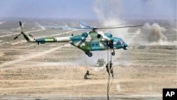 FILE - In this photo from the Russian Defense Ministry Press Service, troops disembark from a Chinese military helicopter during joint war games held by Russia and China in the Ningxia Hui Autonomous Region in northwestern China, Aug. 13, 2021.