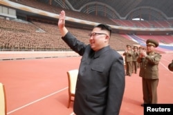 North Korean leader Kim Jong Un waves to the members of the Korean People's Army in this undated photo released by North Korea's Korean Central News Agency, May 13, 2017.