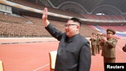 North Korean leader Kim Jong Un waves to the members of the Korean People's Army in this undated photo released by North Korea's Korean Central News Agency, May 13, 2017.