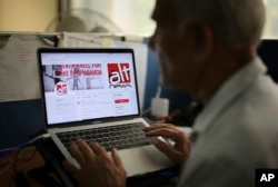 An Indian man browses through the twitter account of Alt News, a fact-checking website, in New Delhi, India, April 2, 2019.