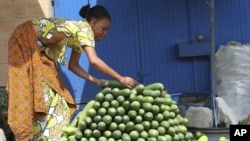 A vendor arranges cucumbers at a market in Abidjan (file photo)