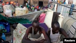 Displaced men rest in an improvised shelter at Tomping camp, where some 17,000 displaced people who fled their homes after violence erupted in South Sudan's capital Juba in mid-December are being sheltered by the United Nations, in Juba Jan. 10, 2014. 