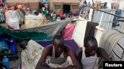 Displaced men rest in an improvised shelter at Tomping camp, where some 17,000 displaced people who fled their homes after violence erupted in South Sudan's capital Juba in mid-December are being sheltered by the United Nations, in Juba, Jan. 10, 2014. 