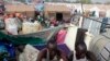 Displaced men rest in an improvised shelter at an UNMISS base in Juba, where nearly 30,000 people who were forced from their homes when violence erupted in South Sudan have sought shelter. 