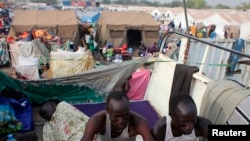 Displaced men rest in an improvised shelter at an UNMISS base in Juba, where nearly 30,000 people who were forced from their homes when violence erupted in South Sudan have sought shelter. 