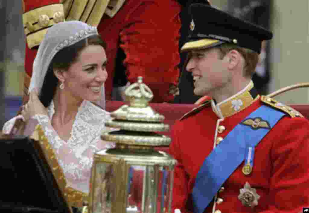 Britain's Prince William and his wife Kate, Duchess of Cambridge, left, smiles as they leave Westminster Abbey at the Royal Wedding in London Friday, April 29, 2011. (AP Photo/Gero Breloer)