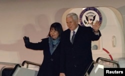 FILE - U.S. Vice President Mike Pence and his wife, Karen, wave upon their arrival at Yokota Air Base on the outskirts of Tokyo, Japan, Feb. 6, 2018.