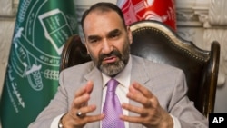 FILE - Atta Mohammad Noor, governor of the Balkh province, talks during an interview with The Associated Press at his home in Kabul, Afghanistan, Aug. 3, 2015. 