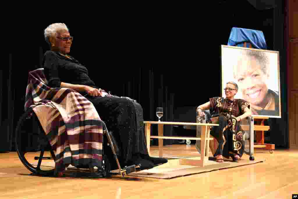 Maya Angelou talks with Johnnetta Cole, director of the National Museum of African Art, at Maya Angelou's portrait unveiling at the Smithsonian's National Portrait Gallery in Washington, April 5, 2014.