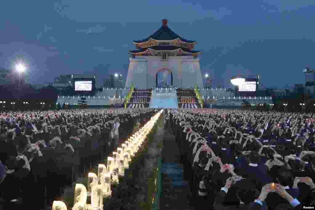 Buddhists pray during a ceremony to commemorate the birth of Buddha, at Chiang Kai-shek Memorial Hall in Taipei, Taiwan.