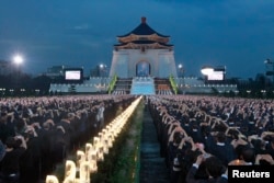 FILE - Buddhists pray during a ceremony to commemorate the birth of Buddha, at the Chiang Kai-shek Memorial Hall in Taipei.