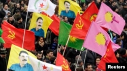 FILE - Kurds take part in a demonstration calling for the release of Kurdistan Workers Party [PKK] leader Abdullah Ocalan, in Strasbourg, eastern France, Feb. 16, 2013. 