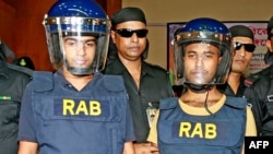 Abdul Hakim (L), 22, and Mahmudul Hasan, 17, members of homegrown banned militant outfit Jamaayetul Mujahideen Bangladesh (JMB) are presented to the media after they surrendered in Bogra on October 5, 2016.