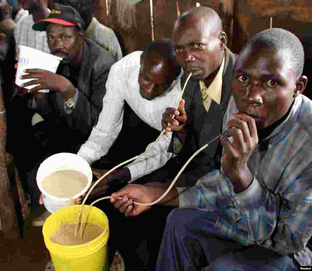 Kenyans consume a locally brewed drink in the Kawangware area, on the outskirts of Nairobi, Kenya, June 26, 2005.