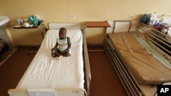 FILE - A sick child in a Dakar hospital.