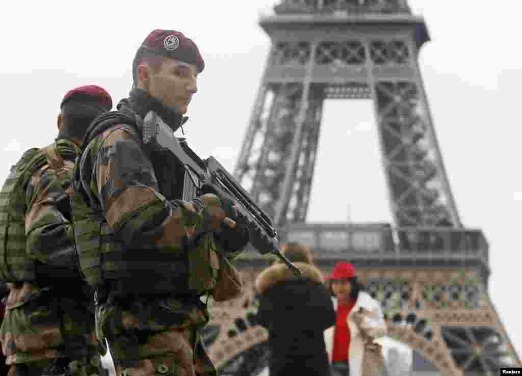 French soldiers patrol near the Eiffel Tower in Paris as part of the highest level of &quot;Vigipirate&quot; security plan after a shooting at the Paris offices of Charlie Hebdo.