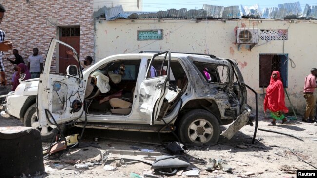 The vehicle wreckage of Somalia's government spokesperson Mohamed Ibrahim Moalimuu is seen at the scene of an explosion Mogadishu, Jan. 16, 2022.