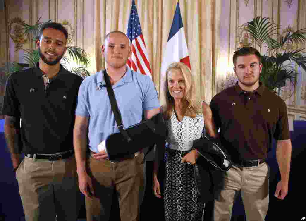 From left, American Anthony Sadler, U.S. Airman Spencer Stone, U.S. Ambassador to France Jane Hartley and U.S. Oregon National Guardsman Alek Skarlatos pose before a news conference at Hartley&#39;s residence in Paris, Aug. 23, 2015.