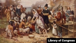 FILE - A painting by Jean Leon Gerome Ferris titled 'The First Thanksgiving' shows pilgrims and Native Americans gathering to share a meal.