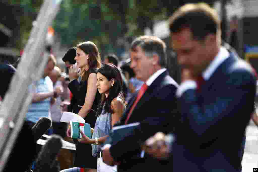 Members of media give live reports across from St. Mary's Hospital exclusive Lindo Wing in London, July 22, 2013.