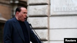 Former Italian Prime Minister Silvio Berlusconi speaks during a rally to protest his tax fraud conviction, outside his palace in central Rome, August 4, 2013. 