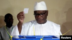 FILE - Ibrahim Boubacar Keita, President of Mali and candidate for Rally for Mali party (RPM), casts his vote at a polling station during a run-off presidential election in Bamako, Aug. 12, 2018.